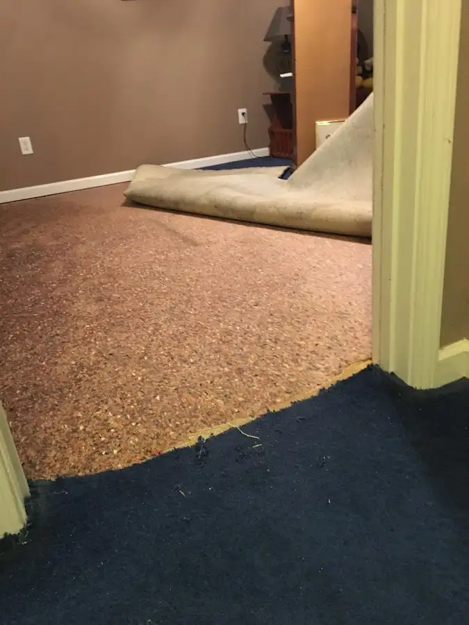 Carpet pad removal revealing water damage during Water Mitigation Services in Pismo Beach